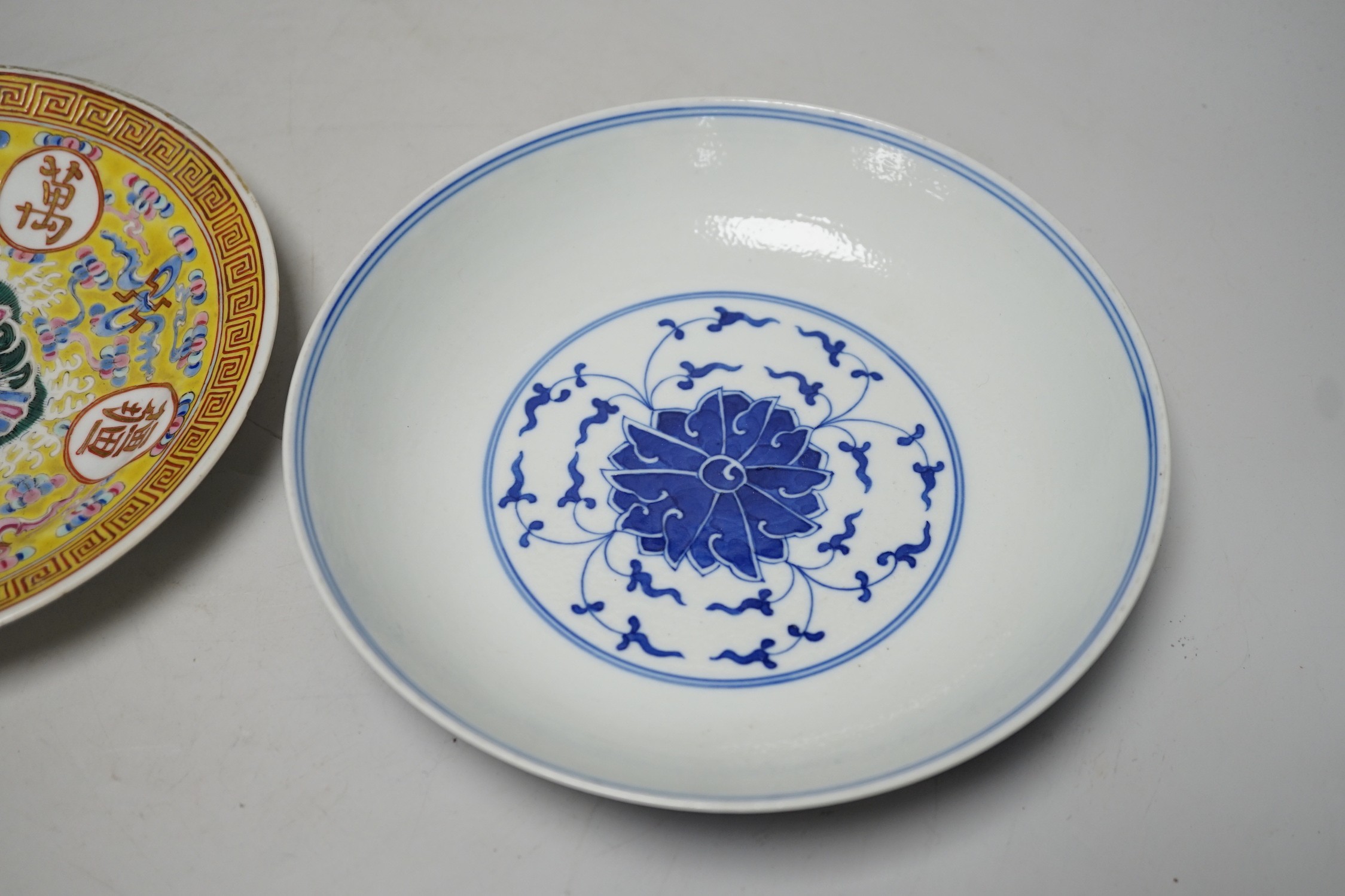 A Chinese blue and white dish and a similar enamelled dish, largest 20cm